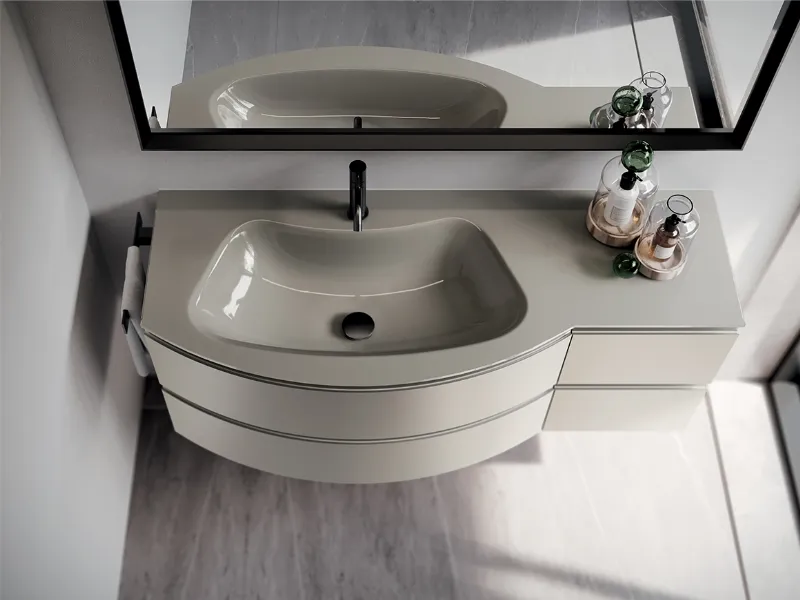 Base sinuosamente stondata e lavabo integrato curvo in cristallo laccato lucido in questa elegante soluzione firmata Ideagroup (collezione Form)